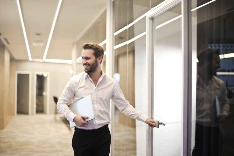 Young Man Walking into Conference Room