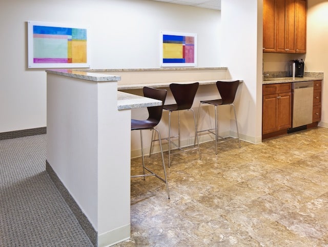 office kitchen area with bar height seating