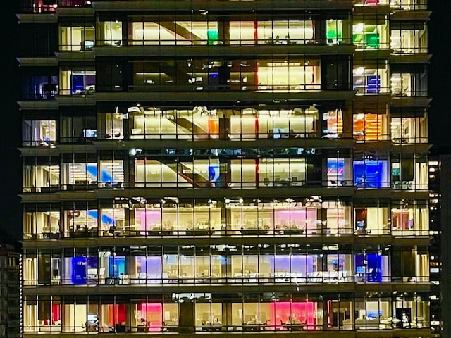 exterior of office building with multi color lights