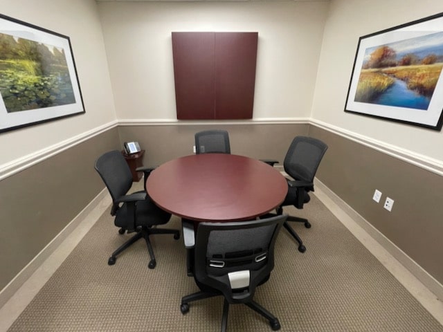 small conference room with round table and 4 chairs