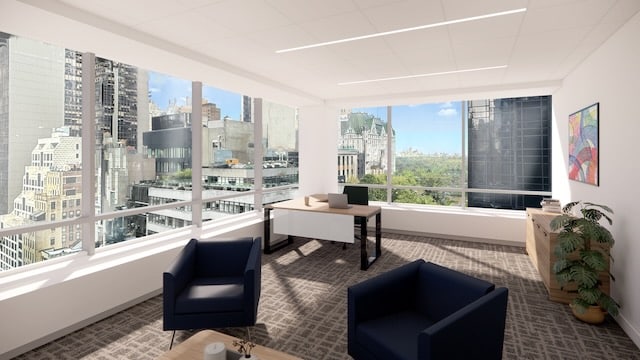 Modern office with large windows, city skyline and park view, two chairs, desk, and bright natural light.