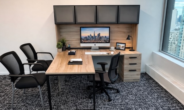 Modern executive office with a wooden desk, computer, chairs, and stunning city view through a large window—perfect for professionals seeking Westchester NY virtual office solutions or upscale Westchester New York executive suites.